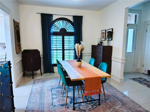 2513 Sandpiper Ave, Mcallen, TX 78504 - dining space featuring light tile patterned flooring, plenty of natural light, a wainscoted wall, and a decorative wall