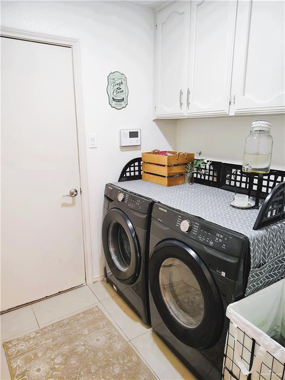 2513 Sandpiper Ave, Mcallen, TX 78504 - clothes washing area with separate washer and dryer, cabinet space, and light tile patterned floors