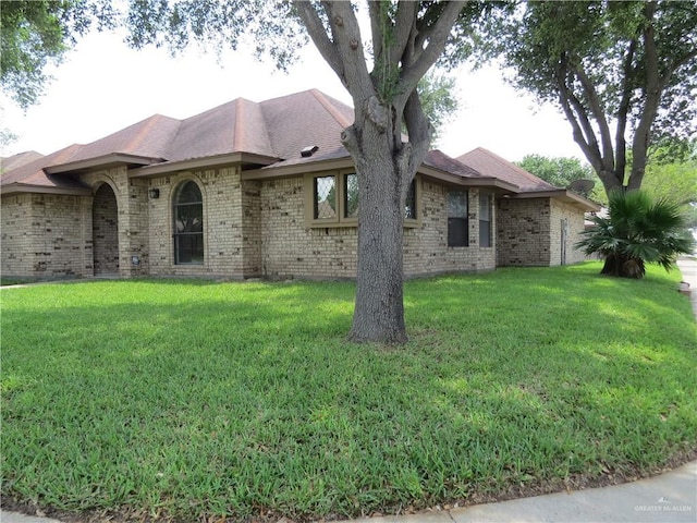 2513 Sandpiper Ave, Mcallen, TX 78504 - view of side of home featuring a yard, brick siding, and roof with shingles
