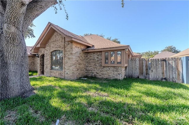 3805 N 1st St, Mcallen, TX 78501 - view of side of home featuring a lawn, fence, and brick siding