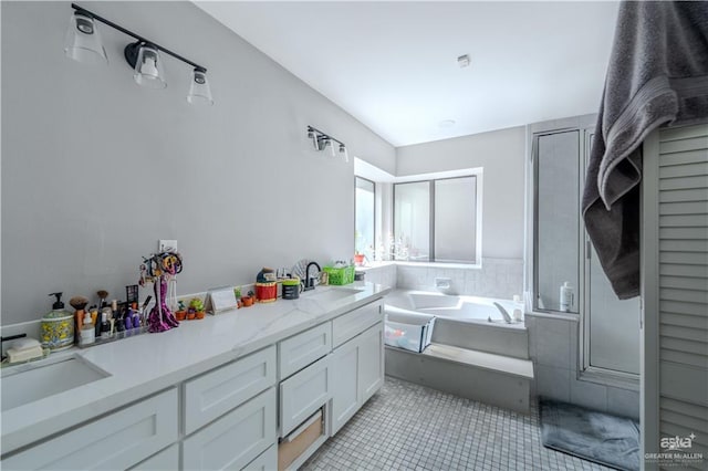 3805 N 1st St, Mcallen, TX 78501 - bathroom featuring tile patterned flooring, a garden tub, double vanity, a sink, and a stall shower