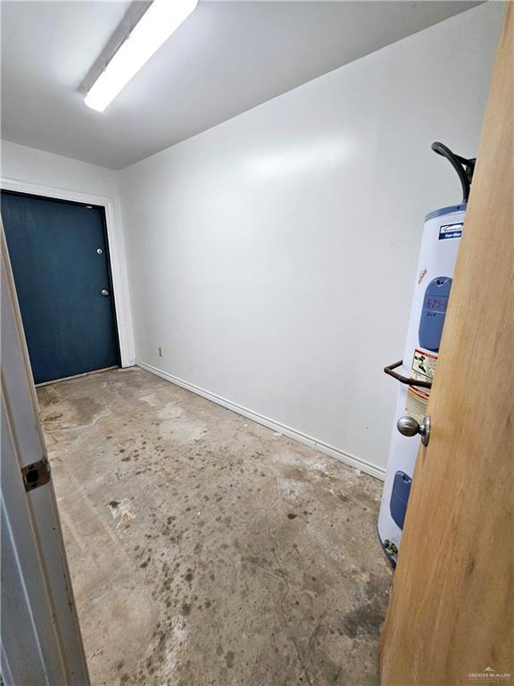 interior space with concrete flooring and water heater