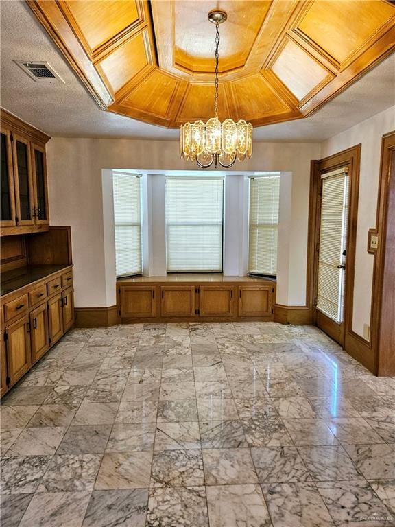 unfurnished dining area featuring a notable chandelier