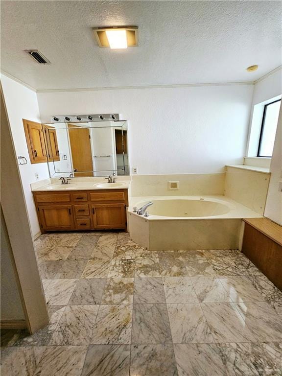 bathroom featuring vanity, a bathtub, and a textured ceiling