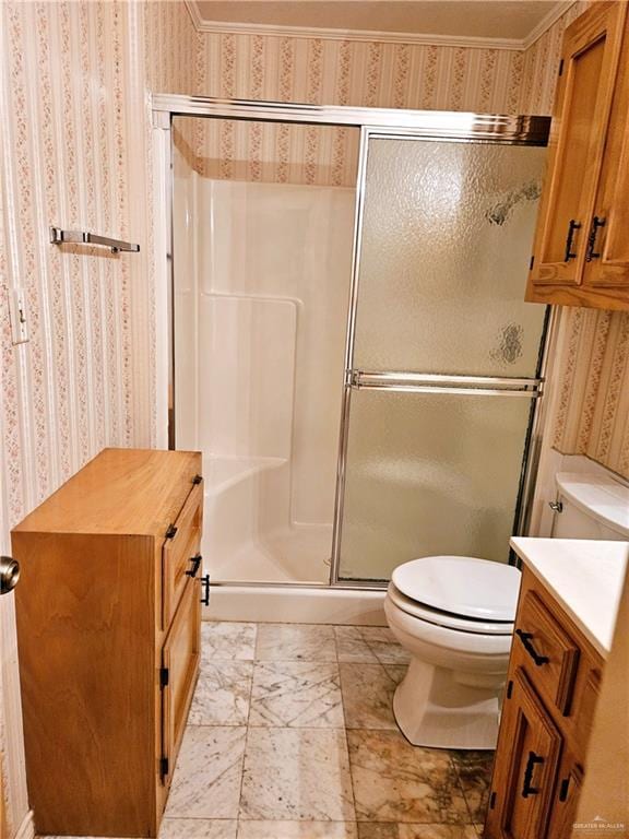 bathroom with an enclosed shower, vanity, crown molding, and toilet