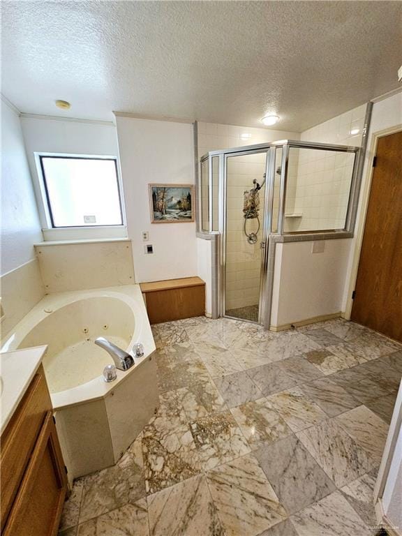 bathroom featuring plus walk in shower, vanity, and a textured ceiling