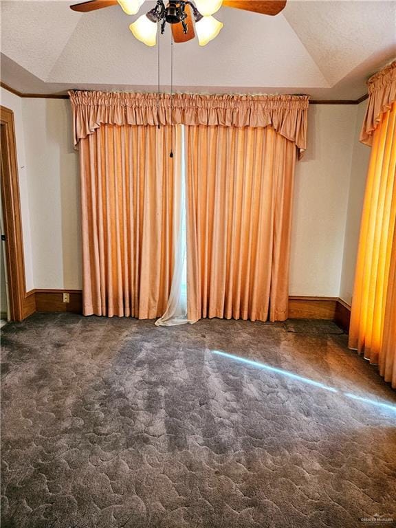 carpeted spare room featuring lofted ceiling, crown molding, and ceiling fan