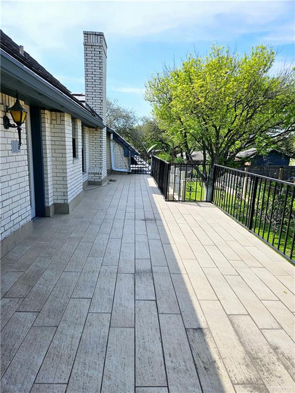 wooden terrace with a patio area