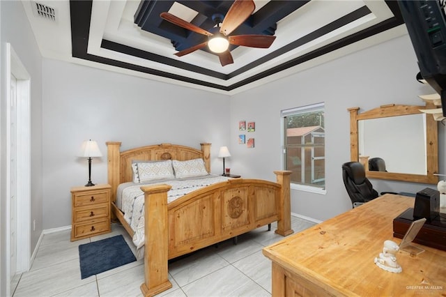 bedroom featuring light tile patterned floors, ceiling fan, and a tray ceiling