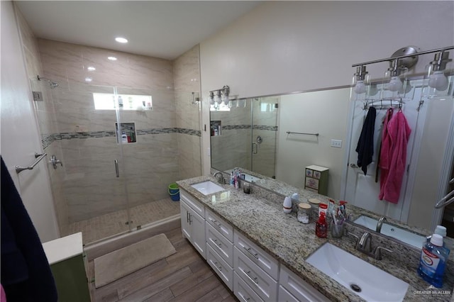 29082 Reynolds Dr, La Feria, TX 78559 - full bath featuring wood finished floors, a shower stall, double vanity, and recessed lighting