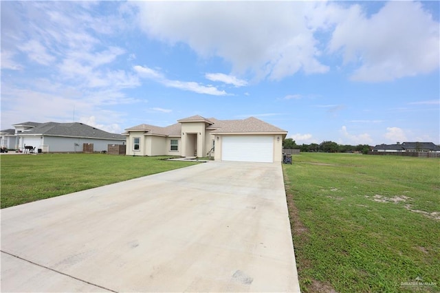 29082 Reynolds Dr, La Feria, TX 78559 - view of front of house featuring stucco siding, concrete driveway, a front yard, and a garage