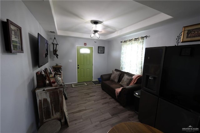 29082 Reynolds Dr, La Feria, TX 78559 - living area featuring a tray ceiling, wood finished floors, and a ceiling fan