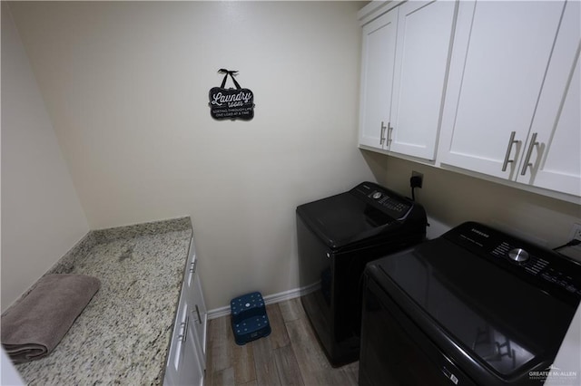 29082 Reynolds Dr, La Feria, TX 78559 - laundry room featuring cabinet space, washer and dryer, and wood finished floors