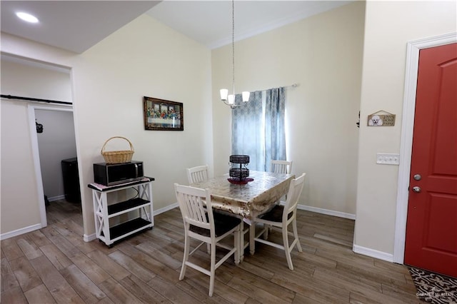 29082 Reynolds Dr, La Feria, TX 78559 - dining space with wood finished floors, a chandelier, and a barn door