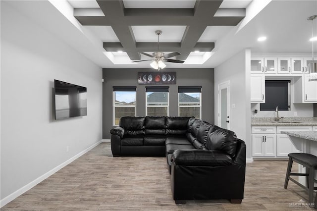 living room with coffered ceiling, ceiling fan, sink, beamed ceiling, and light hardwood / wood-style floors