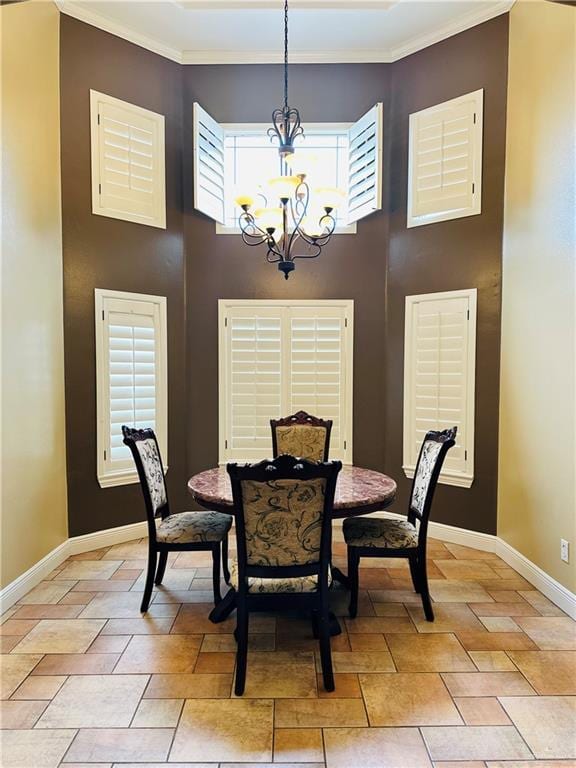 dining area featuring a chandelier, plenty of natural light, and ornamental molding