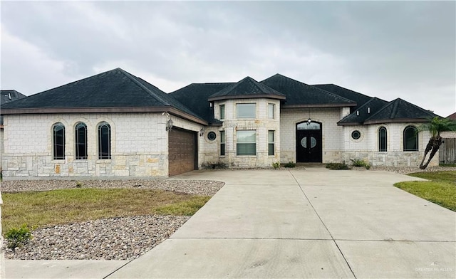 french country inspired facade with a garage