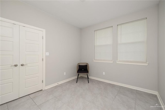 spare room featuring light tile patterned flooring