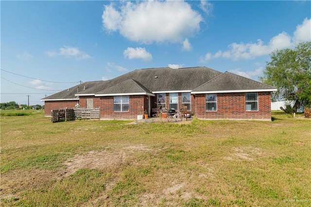 rear view of property featuring a yard