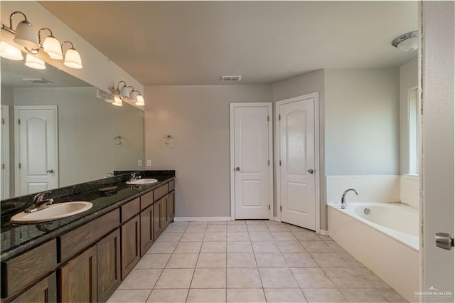 bathroom with vanity, tile patterned floors, and a bathtub