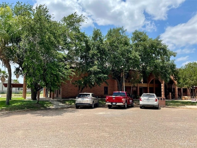 view of front of property with brick siding and uncovered parking