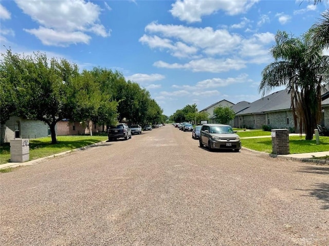 view of road with curbs, sidewalks, and a residential view