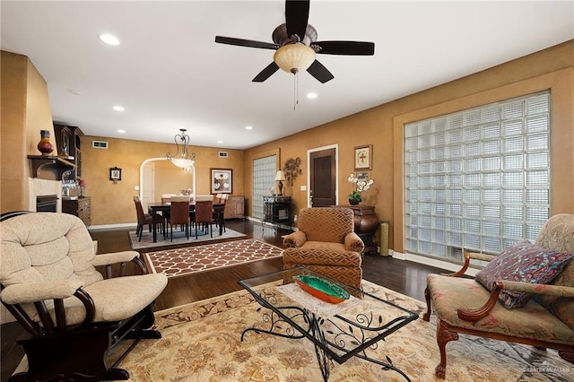 living room featuring hardwood / wood-style floors and ceiling fan