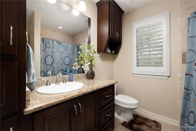 bathroom with tile patterned flooring, vanity, and toilet