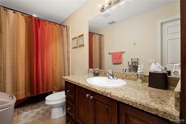 bathroom with tile patterned flooring, vanity, and toilet