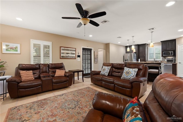 tiled living room with ceiling fan