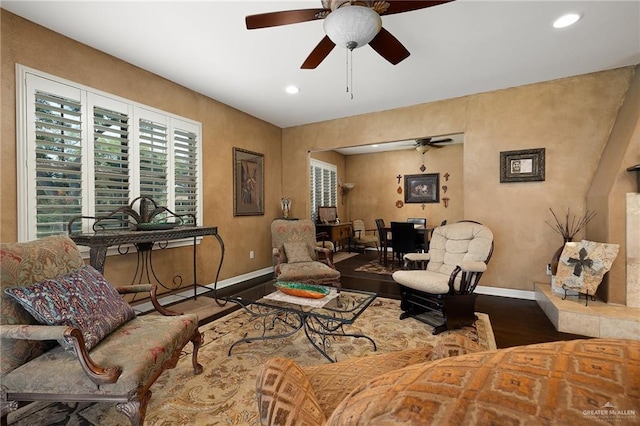 living room with hardwood / wood-style flooring and ceiling fan