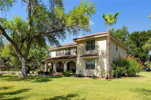 back of property featuring a lawn