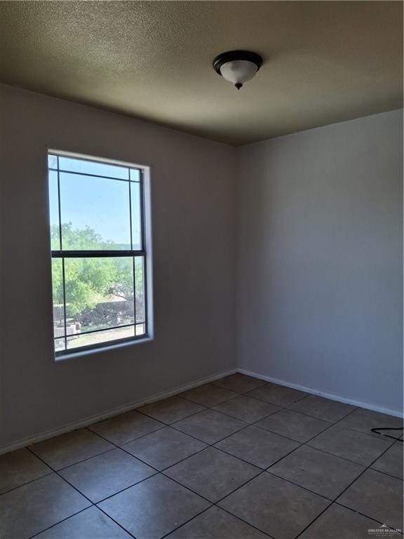 tiled empty room with baseboards