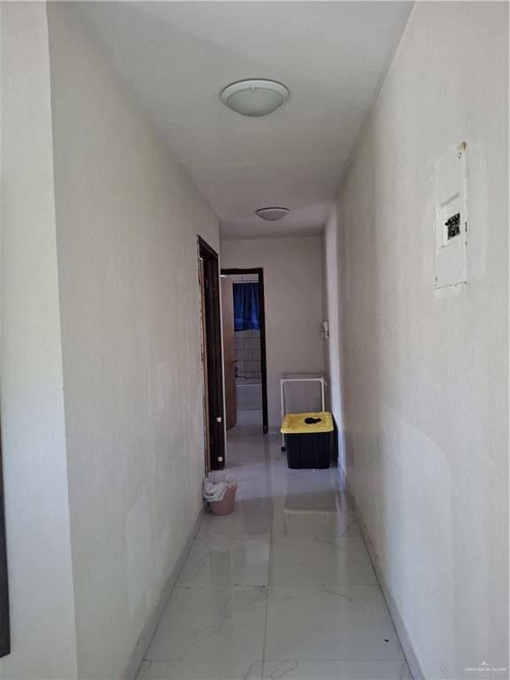corridor featuring marble finish floor