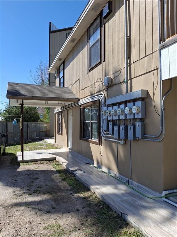 view of home's exterior featuring mail area and fence