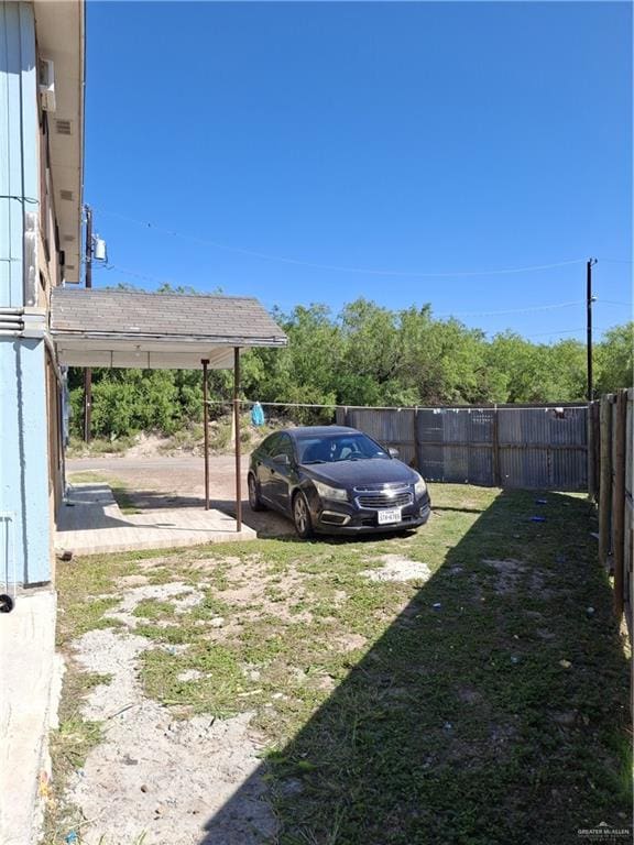 view of vehicle parking featuring a fenced backyard