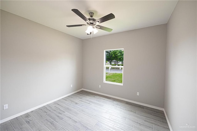 empty room with light wood-style floors, baseboards, and a ceiling fan