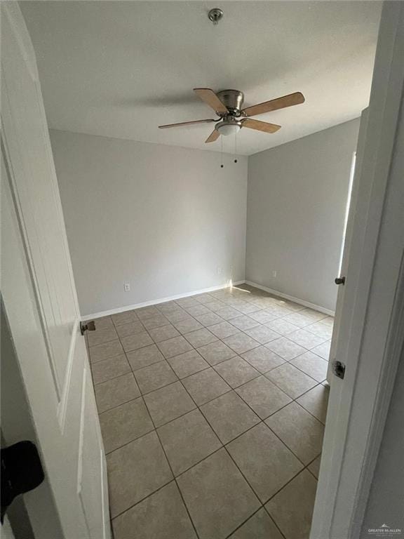 tiled empty room with ceiling fan