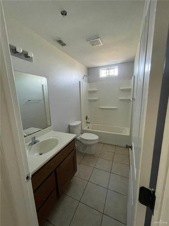 full bathroom with toilet, vanity, tile patterned flooring, and  shower combination