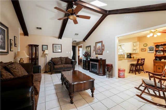 tiled living room with vaulted ceiling with beams, ceiling fan, and a wealth of natural light