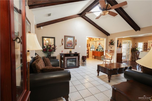 living room with beamed ceiling, ceiling fan, and light tile patterned floors