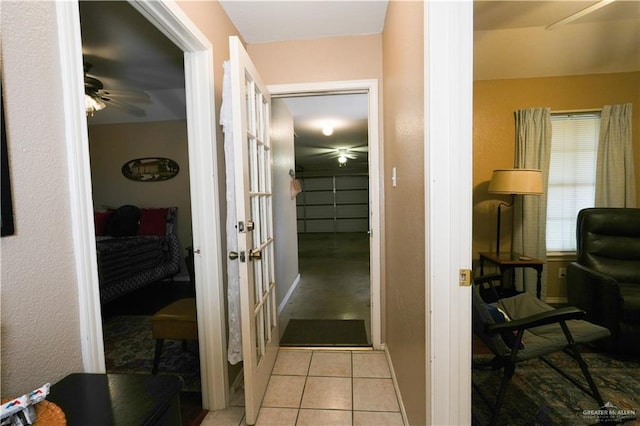 hall with light tile patterned floors