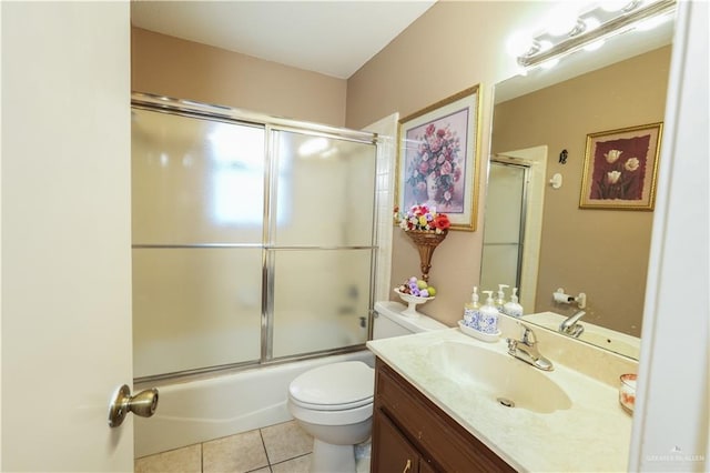 full bathroom featuring tile patterned floors, toilet, combined bath / shower with glass door, and vanity