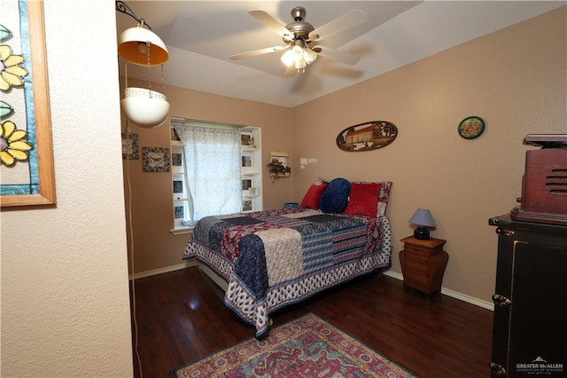 bedroom with ceiling fan and dark wood-type flooring