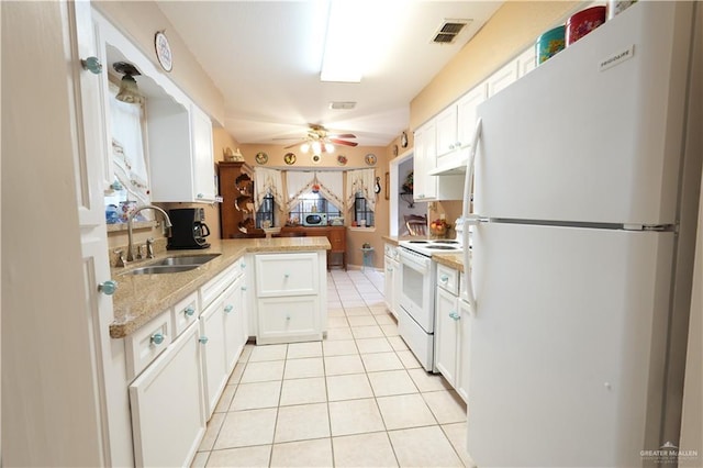 kitchen with ceiling fan, sink, kitchen peninsula, white appliances, and white cabinets