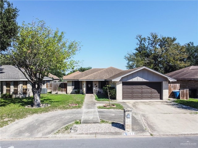 ranch-style house featuring central AC unit, a front yard, and a garage