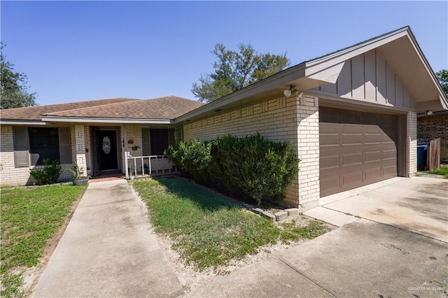 single story home with a garage and a front yard