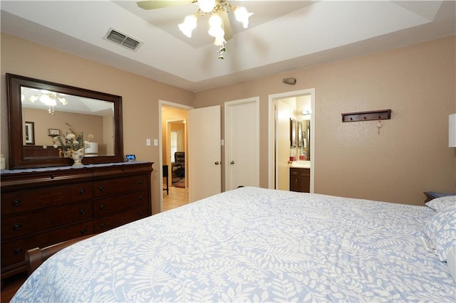 bedroom featuring ceiling fan and ensuite bath