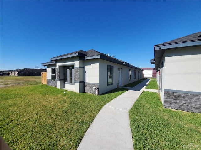 view of side of property with a lawn