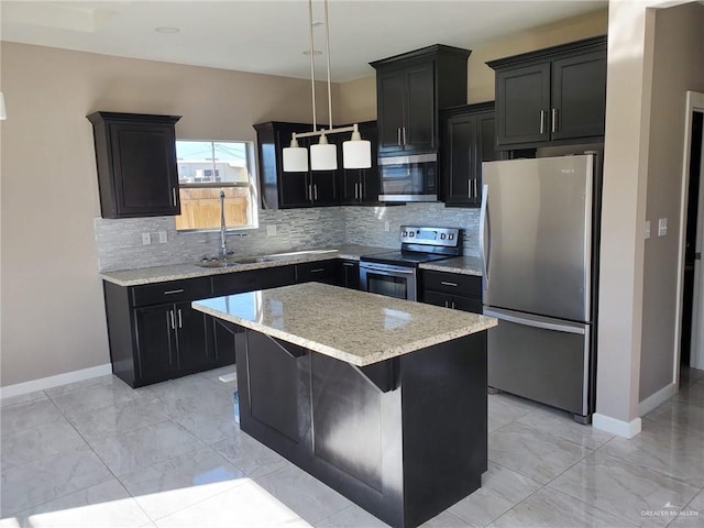 kitchen with a kitchen island, a breakfast bar, sink, hanging light fixtures, and stainless steel appliances